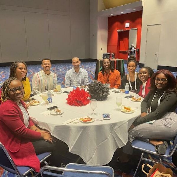 Group of GOLDEN Project staff and students seated at a table